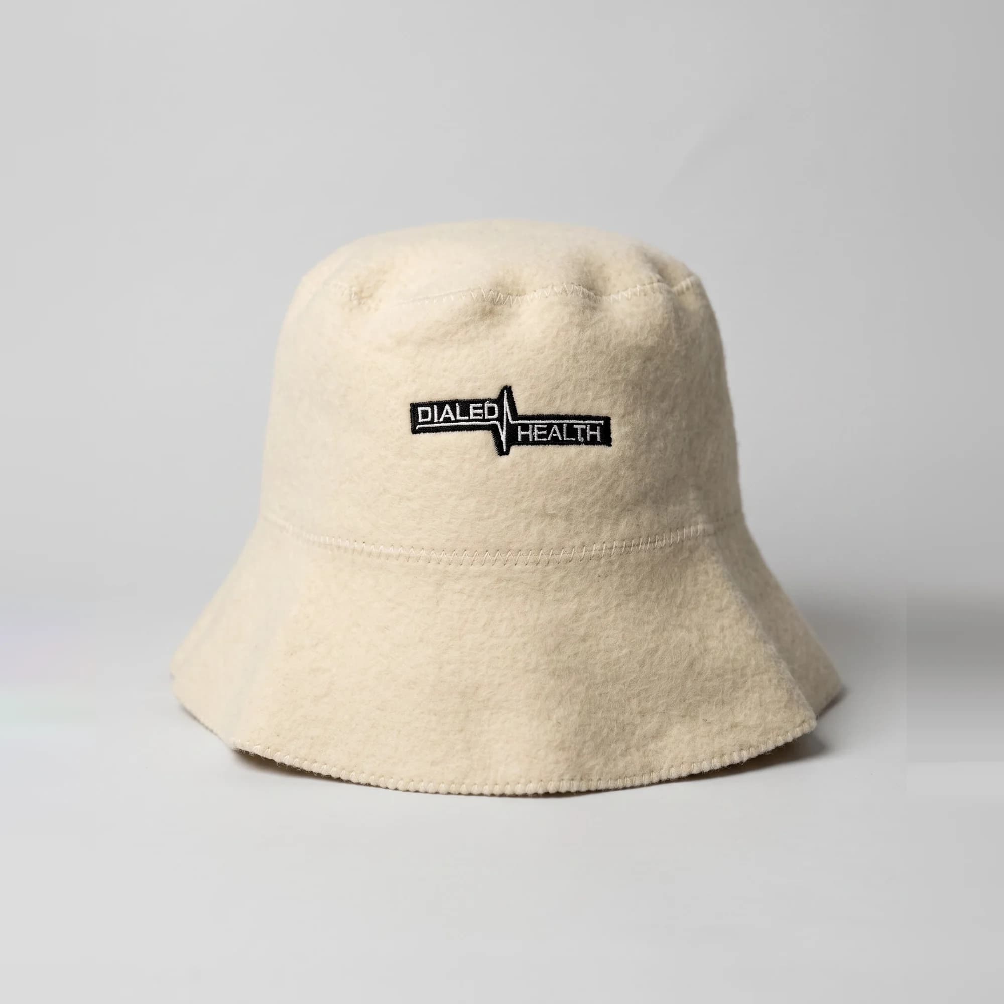 Dialed 100% fine wool bucket hat in cream with an embroidered Dialed logo